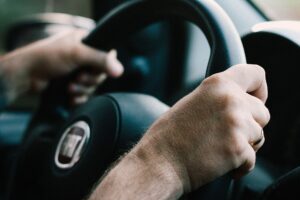 two hands on the steering wheel